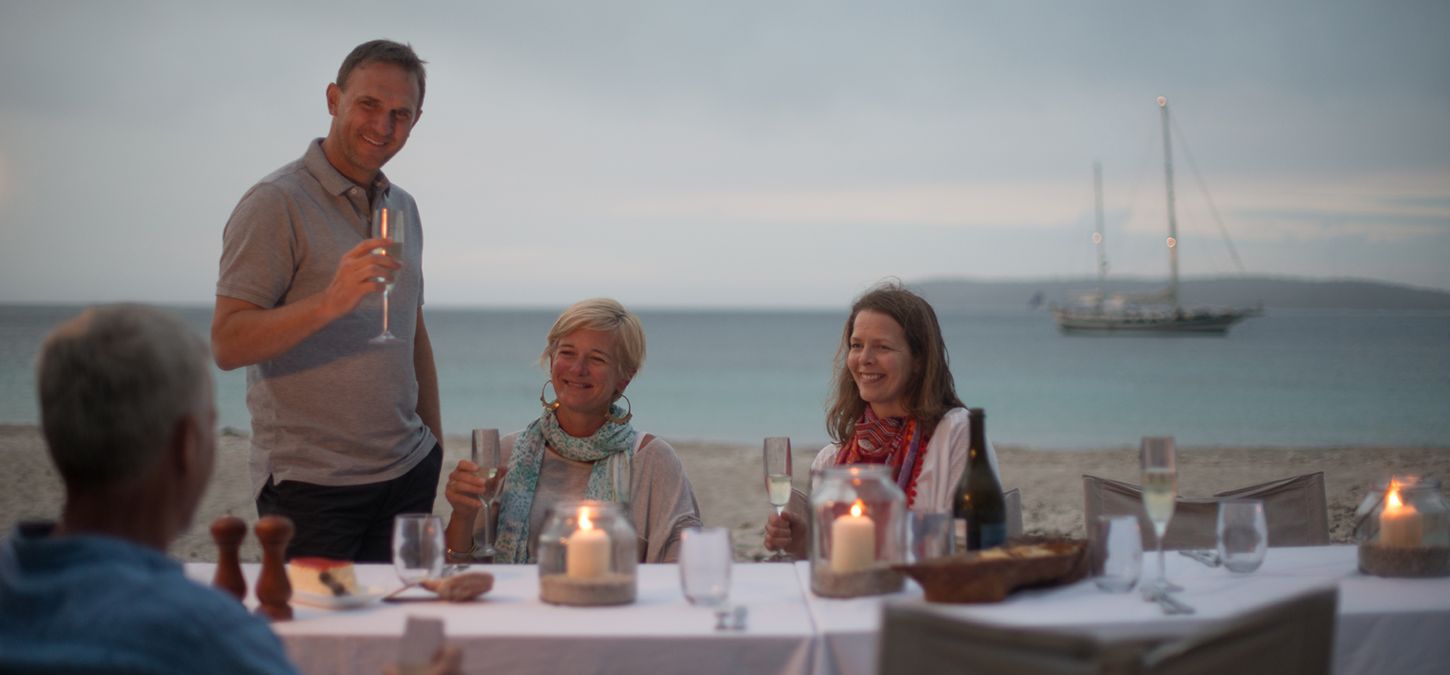 Guests relaxing on the beach at Wineglass Bay