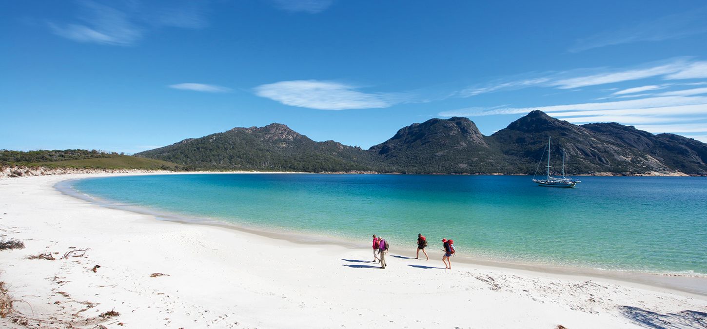 guests walking along beach on Wineglass Bay Sail Walk