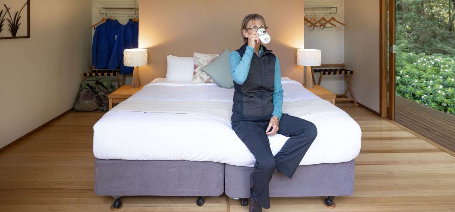 Woman relaxing in her private accommodation on the 12 Apostles Lodge Walk