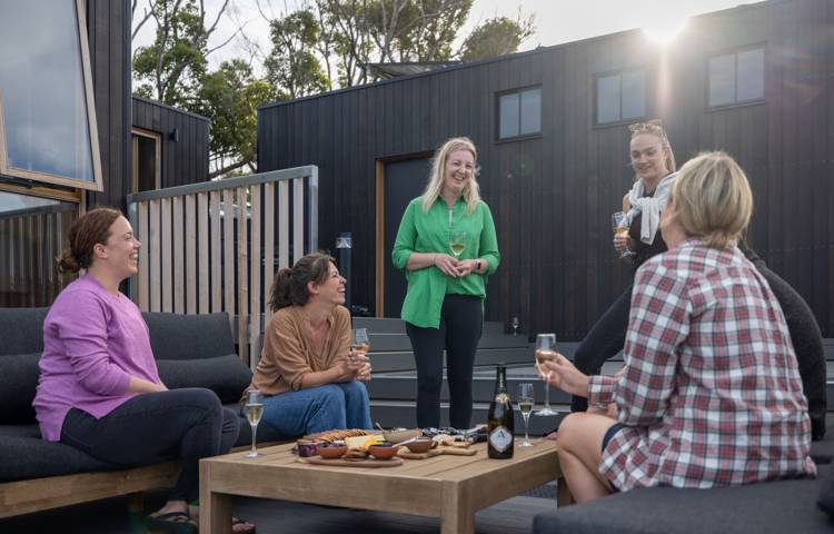 Guests sitting outside at Crescent bay Camp