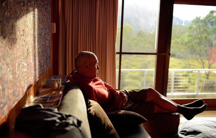 Guest relaxing in the lounge area of our private accommodation, Overland Track, Tasmania