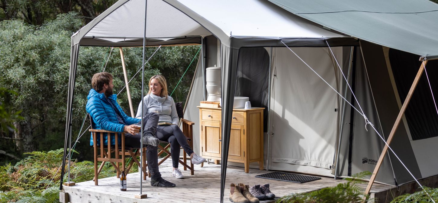 Guests outside luxury tent accommodation at Bruny Island