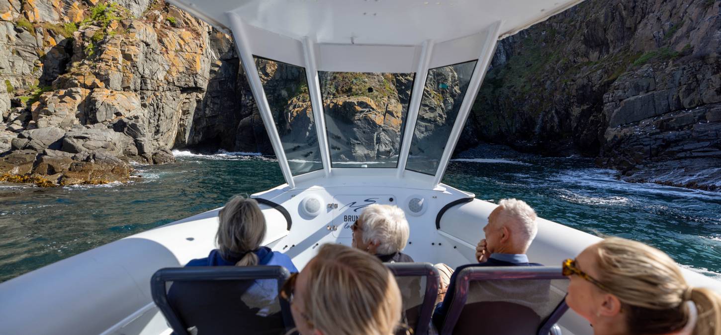 Guests riding on boat in Bruny island walk