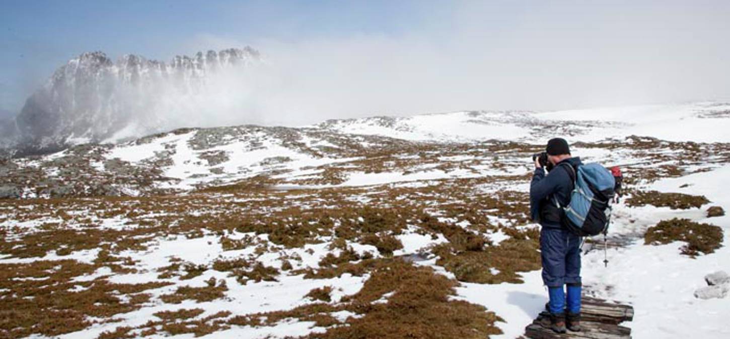 Walker walking through the snow at Crade Mountain trail int eh winter